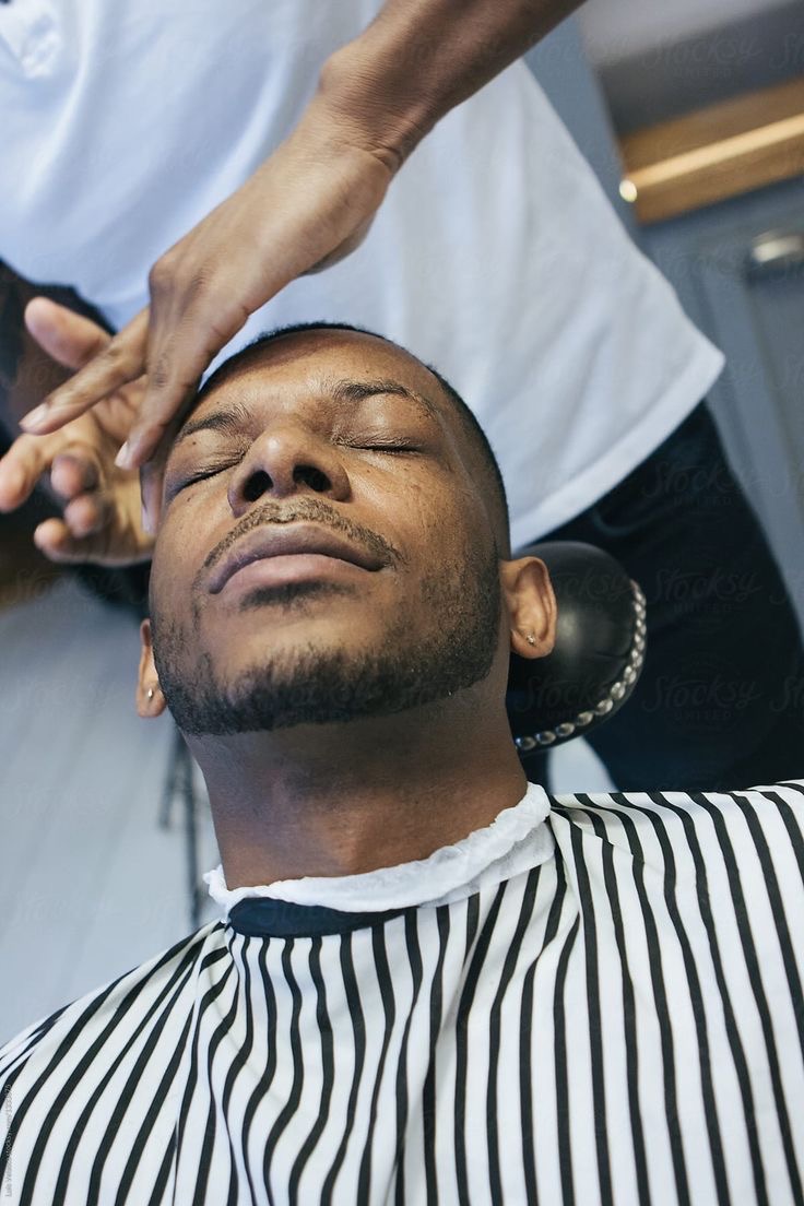 A barber giving a haircut at a Haircuts For a Cause event